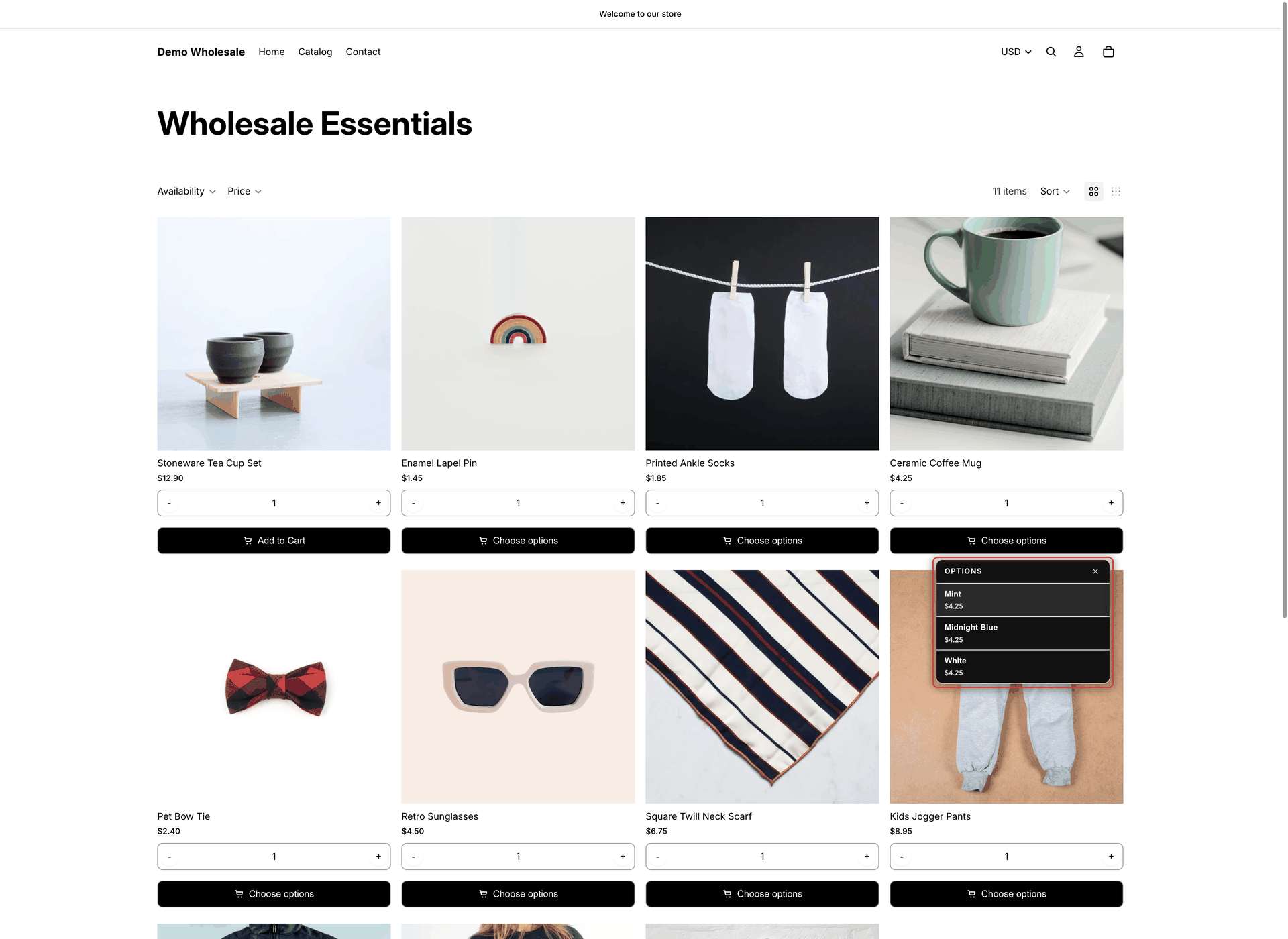 Wholesale Essentials collection page with the variant list open under the Choose options button of the Ceramic Coffee Mug card, listing Mint, Midnight Blue and White with their prices